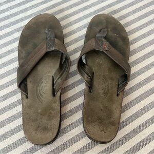 Very worn Gray women’s rainbow flip flops